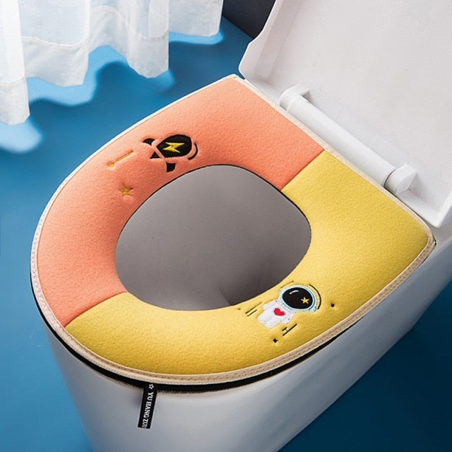 Tapis de siège de toilette astronaute orange et jaune
